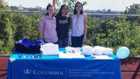 Three members of the Community Outreach and Engagement team stand outside